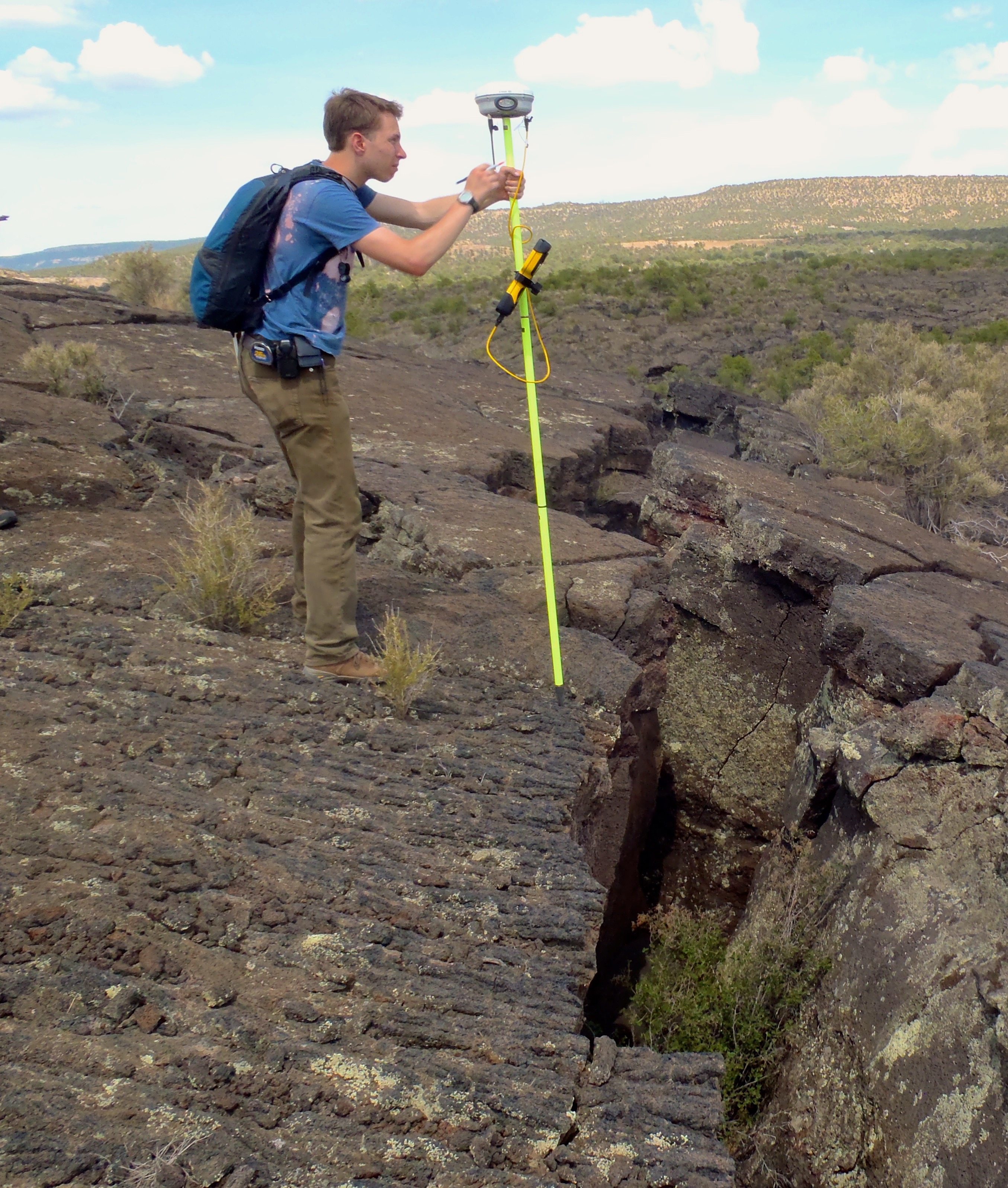 Using a differential GPS rover unit in El Malpais National Monument, New Mexico during my undergraduate research days